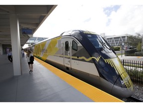 FILE - In this Jan. 11, 2018 file photo a Brightline train is shown at the station, in Fort Lauderdale, Fla. A plan to build a high-speed train between Southern California and Las Vegas is back on track now that a private rail company has taken over the project. Brightline announced Wednesday, Sept. 19, 2018, that it has acquired the rights to XpressWest's 185-mile federally approved rail corridor along Interstate 15.