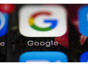 FILE- This April 26, 2017, file photo shows a Google icon on a mobile phone in Philadelphia. New Mexico is suing Google, Twitter and other companies that develop and market mobile gaming apps for children, saying the apps violate state and federal laws by collecting personal information that could compromise privacy. The lawsuit filed in federal court late Tuesday, Sept. 11, 2018, comes as data-sharing concerns persist among users.