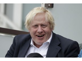 FILE - In this Saturday, Sept. 8, 2018 file photo, Britain's former Foreign Secretary Boris Johnson reacts to seeing photographers taking his picture as he sits in a spectator seat whilst attending the fifth cricket test match of a five match series between England and India at the Oval cricket ground in London. Boris Johnson says Prime Minister Theresa May's blueprint for Brexit will lead to "political and economic disaster," and refuses to rule out trying to replace her.