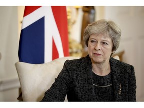 FILE - In this July 24, 2018 file photo, British Prime Minister Theresa May listens at the start of her meeting with the Qatar's emir at 10 Downing Street in London. May has told the BBC in an interview scheduled for broadcast Monday, Sept. 17, 2018, that she gets "irritated" by the debate over her leadership during Brexit negotiations.