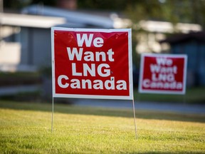 Signs reading "We Want LNG Canada" stand on a lawn in the residential area of Kitimat, British Columbia, Canada, on Monday, Aug. 22, 2016. An announcement on whether the project will go ahead or not is expected as early as next week, according to sources.