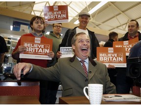 Vice-chairman of Brexit pressure group Leave Means Leave, Nigel Farage, relaxes with supporters in the market area of Bolton, England, during a campaign stop, Saturday Sept. 22, 2018. With barely six months until Britain's Brexit split with the European Union, the Leave Means Leave group are working to gather supporters to their cause.