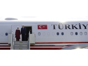 Turkey's President Recep Tayyip Erdogan, right, and his wife Emine, left, arrive at the airport Tegel for an official state visit in Germany at the capital Berlin, Thursday, Sept. 27, 2018.