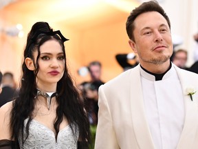 Grimes, left, and Elon Musk attend a Metropolitan Museum of Art's Costume gala in New York in May. The SEC alleges Musk tweeted $420 a share because of its significance in marijuana culture.