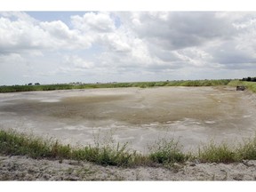 FILE - In this June 23, 2014 file photo, the dried-up bed of an inactive coal ash pond is seen at Duke Energy's Sutton plant in Wilmington, N.C. Duke Energy says heavy rains from Florence have caused a slope to collapse at a coal ash landfill at a closed power station near the North Carolina coast. Duke spokeswoman Paige Sheehan said Saturday night, Sept. 15, 2018, that about 2,000 cubic yards of ash have been displaced at the L. V. Sutton Power Station outside Wilmington.