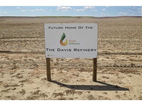 FILE - This July 19, 2018, file photo, shows a sign on property near southwest Belfield, N.D, for the proposedfuture home of the Davis Refinery near Theodore Roosevelt National Park. North Dakota regulators are enlisting an administrative law judge to help untangle some of the legal questions surrounding whether an oil refinery can be built near the park. Meridian Energy Group plans to build the refinery 3 miles from the park. Two environmental groups maintain that Meridian needs state approval for the site. Meridian disputes that.