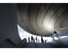 People wait outside of the Steve Jobs Theater before an event to announce new Apple products Wednesday, Sept. 12, 2018, in Cupertino, Calif.