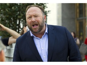 FILE- In this Sept. 5, 2018, file photo conspiracy theorist Alex Jones speaks outside of the Dirksen building of Capitol Hill after listening to Facebook COO Sheryl Sandberg and Twitter CEO Jack Dorsey testify before the Senate Intelligence Committee on 'Foreign Influence Operations and Their Use of Social Media Platforms' on Capitol Hill in Washington. You won't be able use PayPal anymore to buy fluoride-free toothpaste or a bottle of The Real Red Pill Plus from right-wing conspiracy promulgator Alex Jones. The digital payments company is the latest platform to ditch Jones and his Infowars site, which along with conspiracy theories peddles "I Stand With Trump" t-shirts, Wake Up America coffee, dietary supplements and survival food., Friday, Sept. 21, 2018.