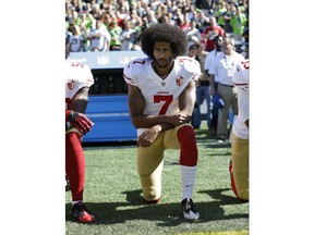 FILE - In this Sept. 25, 2016, file photo, San Francisco 49ers' Colin Kaepernick kneels during the national anthem before an NFL football game against the Seattle Seahawks, in Seattle. Kaepernick has a new deal with Nike, even though the NFL does not want him. Kaepernick's attorney, Mark Geragos, made the announcement on Twitter, calling the former 49ers quarterback an "All American Icon" and crediting attorney Ben Meiselas for getting the deal done.