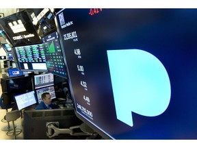 FILE - In this Feb. 22, 2018, file photo, the Pandora logo appears above a trading post on the floor of the New York Stock Exchange. Subscription radio company SiriusXM says it's buying music streaming service Pandora Media Inc. in a stock deal valued at about $3.5 billion that'll allow it to expand its service beyond cars and into homes and other mobile areas.