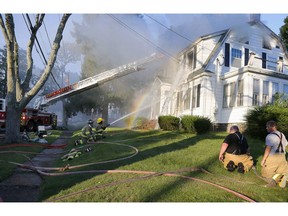 FILE - In this Sept. 13, 2018, file photo, firefighters battle a house fire on Herrick Road in North Andover, Mass., one of multiple emergency crews responding to a series of gas explosions and fires triggered by a problem with a gas line that feeds homes in several communities north of Boston. The pressure in natural gas pipelines prior to a series of explosions and fires in Massachusetts last week was 12 times higher than it should have been. The information was in a letter from the state's U.S. senators to the heads of Columbia Gas and NiSource.