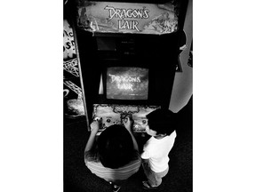 FILE- In this July 29, 1983, file photo Ben Ho plays "Dragon's Lair", a new video game at Captain Video arcade in West Los Angeles. Decades of study have failed to validate the most prevalent fear, that violent games encourage violent behavior. But from the moment the games emerged as a cultural force in the early 1980s, parents fretted about the way kids could lose themselves in games as simple and repetitive as "Pac-Man," "Asteroids" and "Space Invaders."