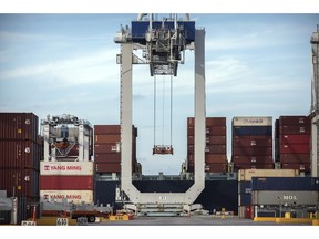 FILE- In this July, 5, 2018, file photo, a ship to shore crane prepares to load a 40-foot shipping container onto a container ship at the Port of Savannah in Savannah, Ga. China said Tuesday, Sept. 18, that it will take "counter-measures" to U.S. President Donald Trump's decision to raise tariffs on $200 billion of Chinese imports and an American business group warned a "downward spiral" in their trade battle appears certain.