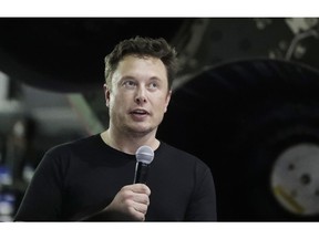 FILE- In this Monday, Sept. 17, 2018, file photo Tesla CEO and SpaceX founder and chief executive Elon Musk speaks after announcing Japanese billionaire Yusaku Maezawa as the first private passenger on a trip around the moon in Hawthorne, Calif. Tesla Inc. has turned over documents to the U.S. Justice Department after statements by Musk about taking the company private, the electric car maker confirmed Tuesday, Sept. 18.