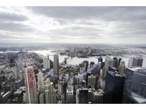 FILE - This May 20, 2015, file photo, shows New York's Financial District, foreground, the Brooklyn Bridge and East River, center, and in the distance Brooklyn as seen from the observatory at One World Trade Center. U.S. middle-class household incomes rose for the third straight year in 2017, as more Americans are working and the number of people with full-time jobs increased.