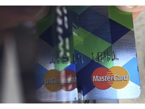 FILE - In this June 15, 2017, file photo, a customer inserts a Mastercard credit card to pay for parking in Haverhill, Mass. Mastercard rolled out a digital trade platform Wednesday, Sept. 12, 2018, designed to make it easier for companies to do business around the world.