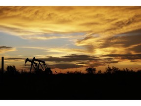 FILE- In this June 5, 2017, file photo pumpjacks work in an oil field at sunset after a thunderstorm passed through the area in Karnes City, Texas. The United States may have reclaimed the title of the world's biggest oil producer sooner than expected. The U.S. Energy Information Administration said Wednesday that America "likely surpassed" Russia in June and August after jumping over Saudi Arabia earlier this year.