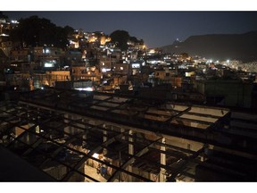 FILE- This Sept. 10, 2017, file photo shows a night view of the Mangueira slum, seen from a squatter building that used to house the Brazilian Institute of Geography and Statistics IGBE) in the Mangueira slum of Rio de Janeiro, Brazil. Global poverty has fallen to a record low. The World Bank says 10 percent of the world's population lived on less than $1.90 a day in 2015, down from 11.2 percent in 2013. That means 735.9 million people lived below the poverty threshold in 2015, down from 804.2 million.