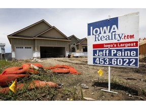 FILE- In this June 27, 2018, file photo, a for sale sign is seen in front of a home for sale in Waukee, Iowa. On Thursday, Sept. 26, The Commerce Department reports on sales of new homes in August.