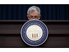 FILE- In this March 21, 2018, file photo Federal Reserve Chairman Jerome Powell looks to his notes as he speaks during a news conference following the Federal Open Market Committee meeting in Washington. No matter your age, what the Federal Reserve does to interest rates will most likely affect you. Economists say the central bank is nearly certain to raise what's called the federal funds rate by a quarter of a percentage point on Wednesday, Sept. 26, 2018, the third such increase this year.