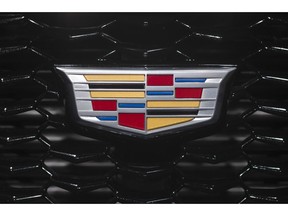 FILE- In this March 27, 2018, file photo the Cadillac emblem is shown on the from grill of its XT4 at the New York Auto Show. General Motors is moving its Cadillac brand headquarters from New York City back to Michigan, four years after heading to the big city to become more cosmopolitan.