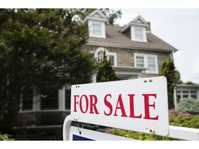 FILE- In this June 8, 2018, file photo a for sale sign stands in front of a house, in Jenkintown, Pa. On Thursday, Sept. 20, Freddie Mac reports on the week's average U.S. mortgage rates.