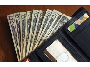 In this June 15, 2018 photo, cash is fanned out from a wallet in North Andover, Mass. On Thursday, Aug. 20, the Federal Reserve reports on household wealth for the April-June quarter.