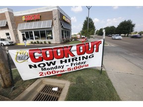 In this is a July 25, 2018, photo cars drive by a help wanted sign at a Cook Out fast food restaurant in Jackson, Miss. On Thursday, Sept. 6, payroll processor ADP reports how many jobs private employers added in August.