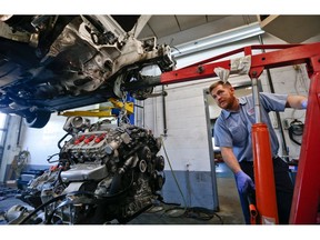 In this April 26, 2018, photo automotive technician Don Dimond prepares to separate an engine and transmission assembly at a repair shop in Harmony, Pa. On Thursday, Sept. 6, the Institute for Supply Management, a trade group of purchasing managers, issues its index of non-manufacturing activity for August.