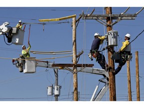 FILE- In this May 9, 2018, file photo students and apprentices work in various stages of training to be a line worker at the Duquesne Light Co. training center in Pittsburgh. They are taking part in a partnership training program with the Community College of Allegheny County. On Friday, Sept. 7, the Labor Department reports on job openings and labor turnover for August.