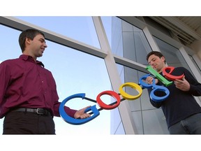 FILE- In this Jan. 15, 2004, file photo Google co-founders Larry Page, left, and Sergey Brin pose for a photo at their company's headquarters in Mountain View, Calif. Twenty years after Page and Brin set out to organize all of the internet's information, the search engine they named Google has morphed into a dominating force in smartphones, online video, email, maps and much more.