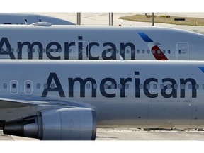 FILE - In this Nov. 6, 2017, file photo, a pair of American Airlines jets are parked on the airport apron at Miami International Airport in Miami. American Airlines is threatening to prohibit customers from making changes to nonrefundable tickets if Congress makes good on a proposal to crack down on unreasonable airline fees. American CEO Doug Parker says his airline would be acting just like many other businesses when customers want to swap their ticket for a different flight or for another day. "We - like the baseball team, like the opera - would say, 'We're sorry, it was nonrefundable,'" Parker said this week.