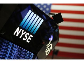 FILE - In this Dec. 27, 2017, file photo, a logo for the New York Stock Exchange is displayed above the trading floor. The U.S. stock market opens at 9:30 a.m. EDT on Tuesday, Sept. 25, 2018.