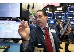 Trader Tommy Kalikas works on the floor of the New York Stock Exchange, Thursday, Sept. 20, 2018. A wave of buying sent U.S. stocks solidly higher on Wall Street Thursday, pushing the Dow Jones Industrial Average above the all-time high it closed at in January.