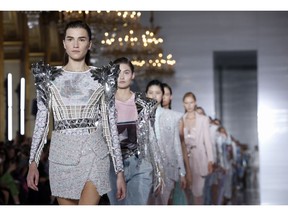 Models wear creations for Balmain Spring/Summer 2019 ready-to-wear fashion collection presented in Paris, Friday, Sept. 28, 2018.