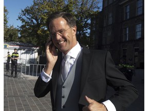 Dutch Prime Minister Mark Rutte flashes a thumbs up as he talks on in his phone in The Hague, Netherlands, Tuesday, Sept. 18, 2018, prior to a ceremony marking the opening of the parliamentary year with a speech by King Willem-Alexander outlining the government's budget plans for the year ahead.