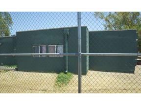 FILE - In this June 28, 2018, file photo, buildings that house juveniles and operations on the grounds of Southwest Key Campbell, a shelter for children that have been separated form their parents in Phoenix, Ariz. are seen. Arizona officials have moved to revoke the licenses for the nonprofit that houses immigrant children after it missed a deadline to show that all its employees passed background checks.