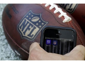 In this Thursday, Aug. 30, 2018, photo apps for NFL and Yahoo Sports are displayed on a phone on the sidelines before a preseason NFL football game between the Philadelphia Eagles and the New York Jets in Philadelphia. As the regular season starts Thursday, Sept. 6, the league is finally dropping a requirement that viewers sign in with a cable or satellite subscription, as it seeks to expand its online audience at a time when TV ratings are declining. The subscription-free games will be available on the NFL app and the Verizon-owned Yahoo Sports, Tumblr and AOL apps.