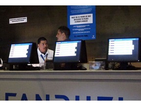 This July 14, 2018 photo, workers at the FanDuel sports book at the Meadowlands Racetrack in East Rutherford N.J. prepare to take bets moments before opening.   New Jersey gambling regulators are investigating whether FanDuel should be ordered to pay a New Jersey man $82,000 for a bet he made on a football game at what the company said were erroneously high odds.