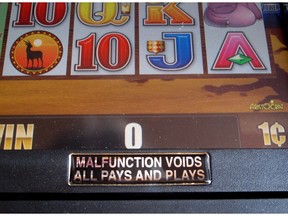 This Sept 27, 2018, photo shows a sign affixed to the surface of a slot machine warning gamblers that any malfunction of the machine voids that play and cancels any jackpots that might have been won. Technical malfunctions are not uncommon in the gambling industry and when they occur, they almost always void the bet.