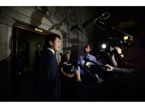 Prime Minister Justin Trudeau pauses to talk to reporters as he makes his way into the House of Commons on Parliament Hill in Ottawa on Wednesday, Sept. 26, 2018.