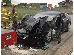 FILE - In this May 11, 2018, file photo, released by the South Jordan Police Department shows a traffic collision involving a Tesla Model S sedan with a fire department mechanic truck stopped at a red light in South Jordan, Utah. Heather Lommatzsch, the Utah driver who slammed her Tesla into the stopped firetruck at a red light while using the vehicle's semi-autonomous function, is suing the company. (South Jordan Police Department via AP, File)