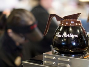 The parent company of Tim Hortons says it has reached an agreement with the head of an unsanctioned franchisee group who had his four restaurants seized.