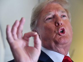 U.S. President Donald Trump speaks to the press aboard Air Force One on September 7, 2018.