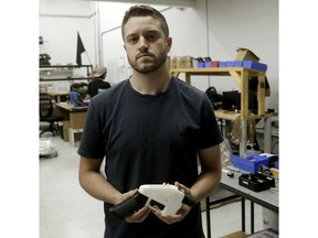 FILE - In this Aug. 1, 2018, file photo, Cody Wilson, with Defense Distributed, holds a 3D-printed gun called the Liberator at his shop, in Austin, Texas. Authorities in Taiwan have arrested Wilson who is wanted in the U.S. over an accusation that he had sex with an underage girl and paid her $500 afterward, official media reported.