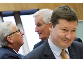 FILE - In this May 3, 2017 file photo, Martin Selmayr, right, attends a meeting with EU chief Brexit negotiator Michel Barnier, center, and European Commission President Jean-Claude Juncker at EU headquarters in Brussels. The European Union's official transparency watchdog on Tuesday, Sept. 4, 2018 said the EU's executive Commission put public trust at risk by fast-tracking the appointment of Martin Selmayr. Selmayr, Juncker's former head of cabinet, was appointed Commission Secretary-General in February 2018 at a meeting that saw him promoted twice within minutes.