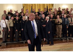 In this Sept. 5, 2018, photo, President Donald Trump responds to a reporters question during an event with sheriffs in the East Room of the White House in Washington.