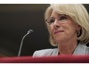 FILE - in this June 5, 2018, file photo, Education Secretary Betsy DeVos pauses as she testifies on Capitol Hill in Washington. Preliminary data obtained by The Associated Press show the Trump administration is granting only partial loan forgiveness to the vast majority of students it approves for help because of fraud by for-profit colleges. The data demonstrate the impact of DeVos' new policy of tiered relief, in which students swindled by for-profit schools are compensated based on their earnings after the program.