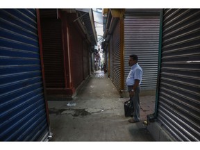 In this Sept 7, 2018 photo, a man walks in the empty and shuttered halls of the Oriental Market during a 24 hour national strike, in Managua, Nicaragua. In June, the country's economic activity was down 12.1 percent compared to a year earlier, according to the central bank.