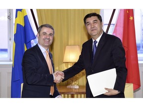 FILE - In this March 23, 2017 file photo, China's Energy Minister Nur Bekri, right, shakes hands with Sweden's Minister for Energy Ibrahim Baylan at the Swedish Government headquarters Rosenbad in Stockholm. The head of China's energy planning agency, one of the most senior officials from the Uighur ethnic minority in China's Muslim northwest, is suspected of unspecified "severe discipline violations," the official term for corruption, the ruling Communist Party's discipline agency said Friday, Sept. 21, 2018.